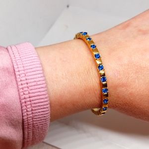 Gold tone blue rhinestone bangle bracelet